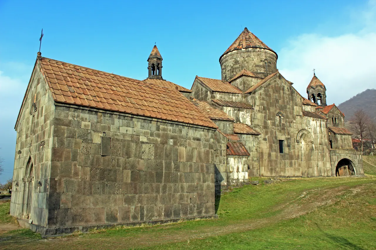 The grey stone churches and gavit halls of Haghpat monastery clustered on a green plateau above the Debed valley in northern Armenia