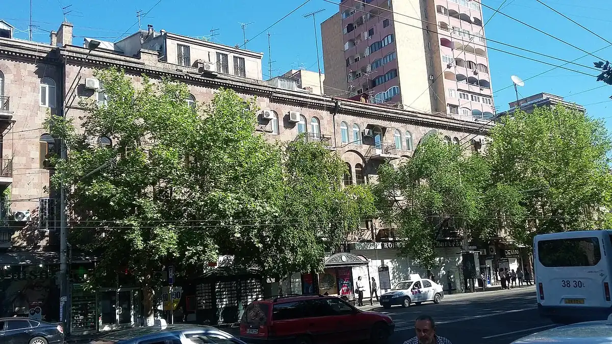 Mashtots Avenue in central Yerevan with traffic, trees and stone apartment buildings
