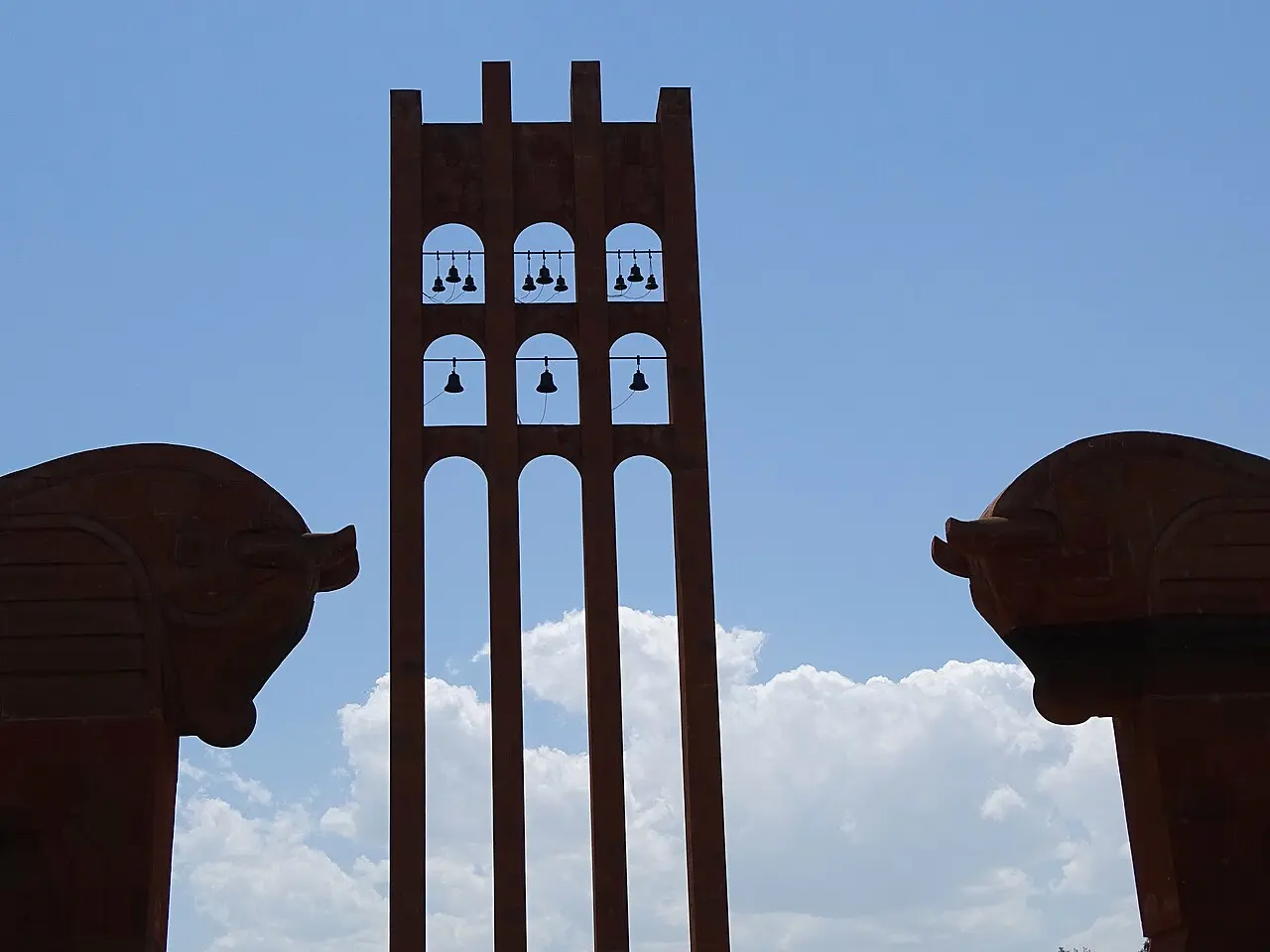 Two sculpted winged bulls flanking the approach to the Sardarapat bell tower