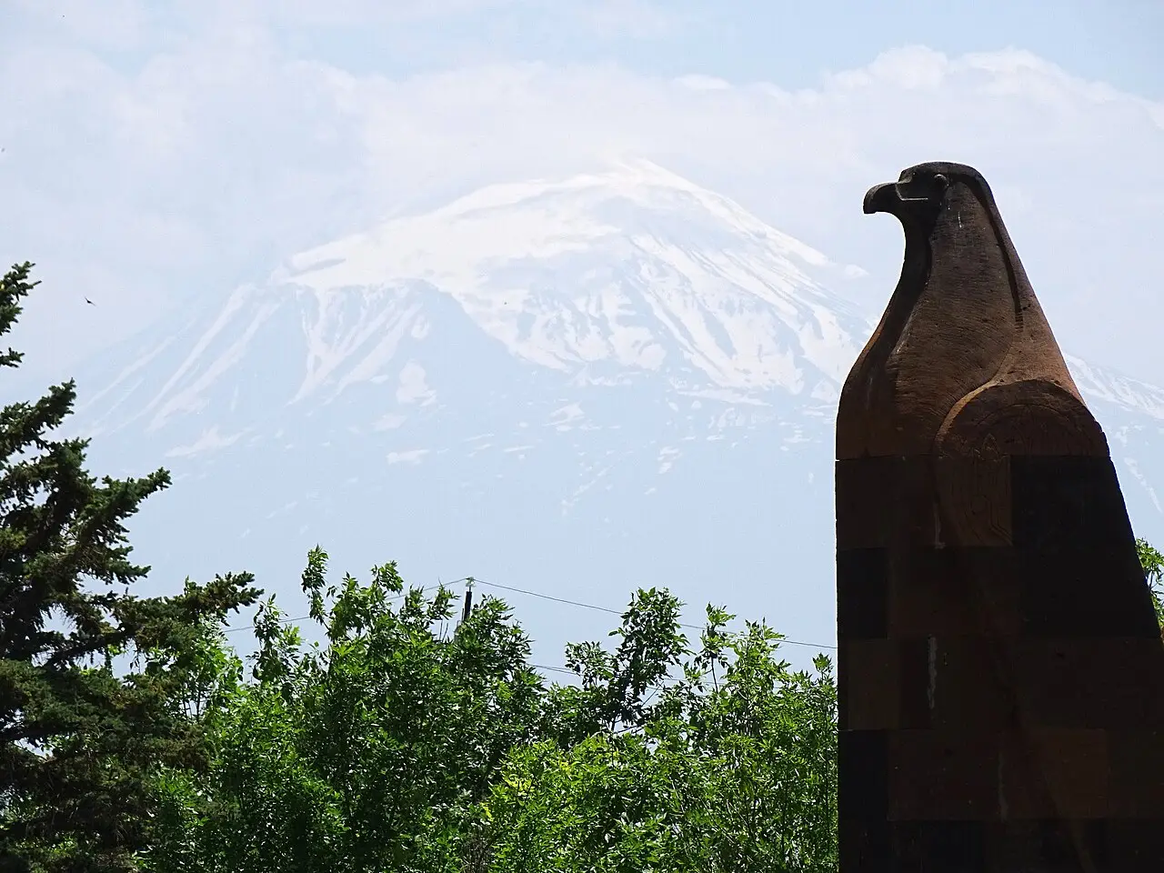 A stone eagle sculpture at Sardarapat with Mount Ararat on the horizon