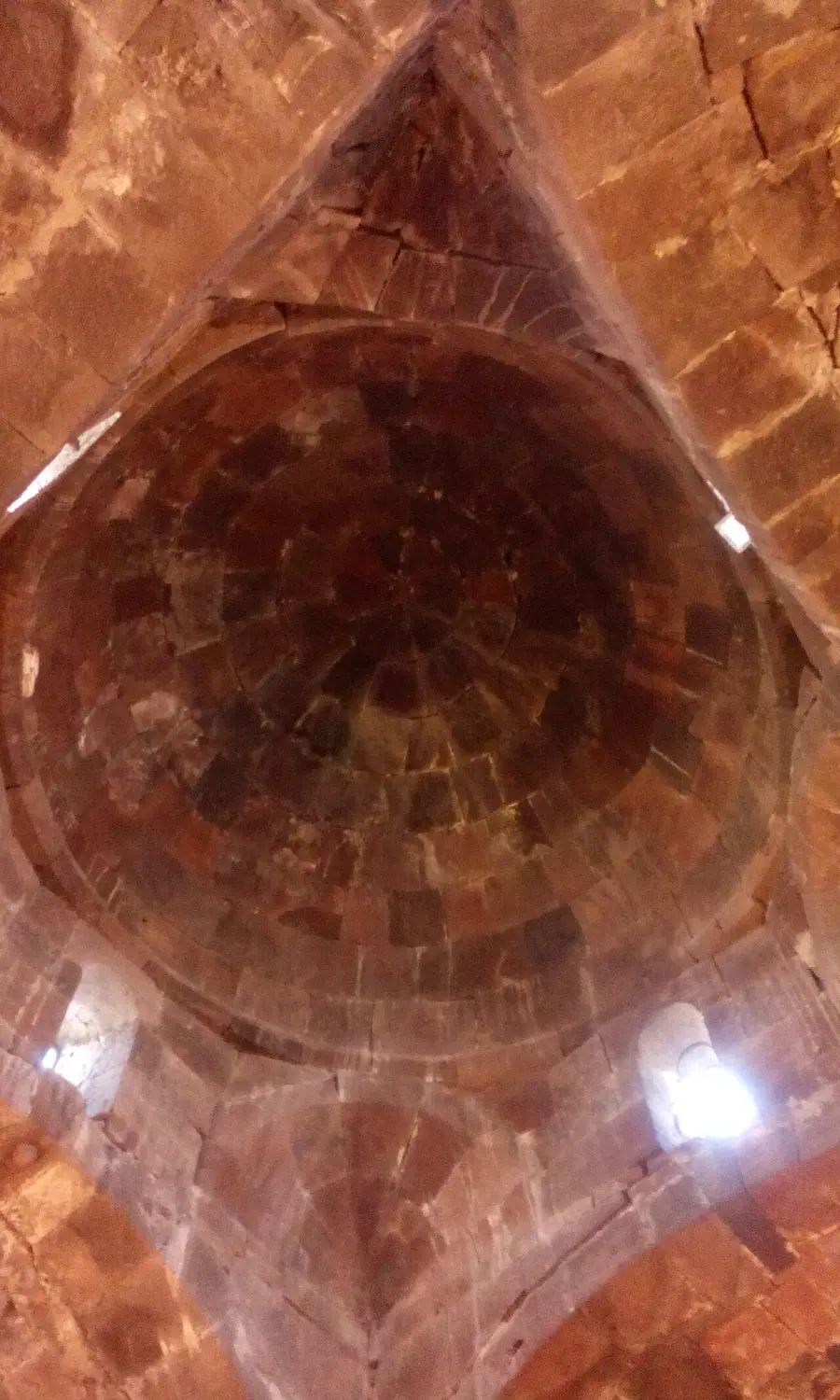 The dim stone interior, dome and altar of the Church of the Holy Apostles at Sevanavank