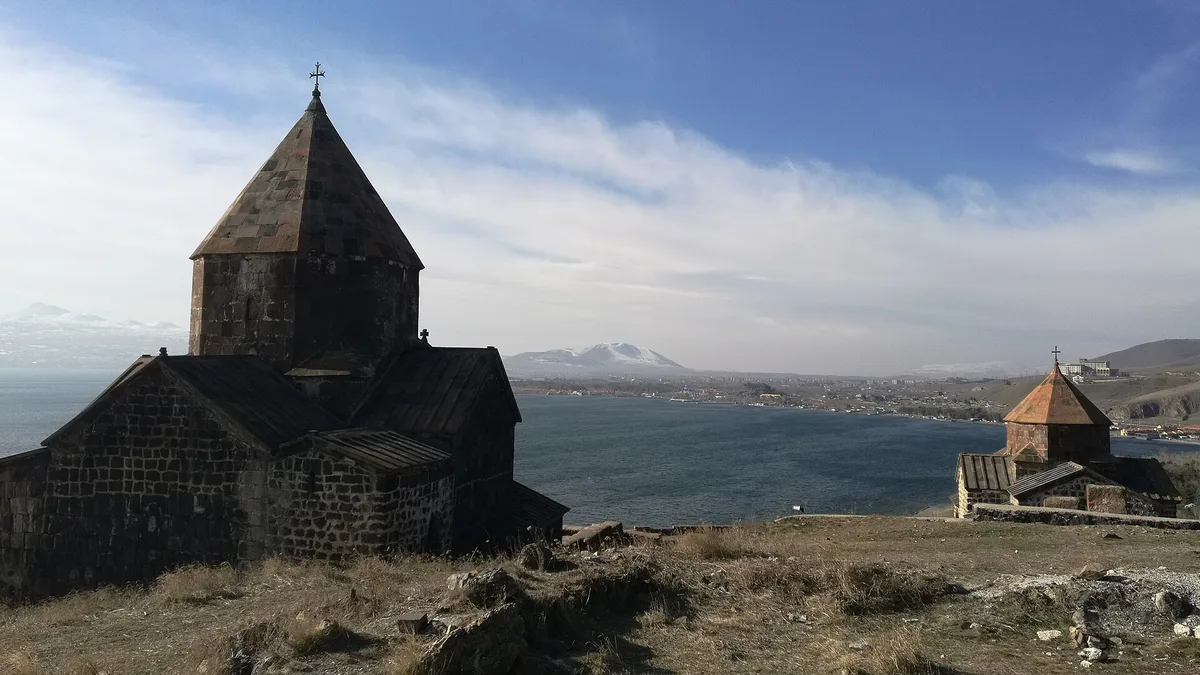 A cruciform church of Sevanavank built of dark tuff with a conical dome on an octagonal drum