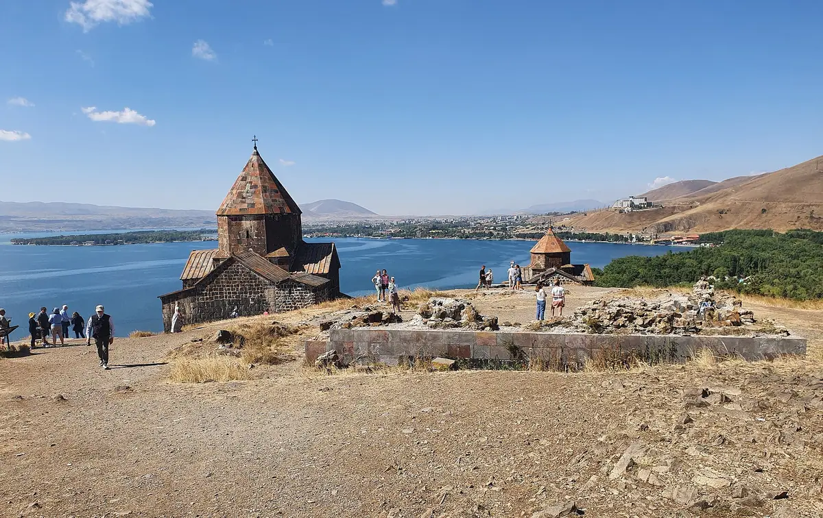 The churches of Sevanavank above the wide blue sweep of Lake Sevan and its far mountain shore