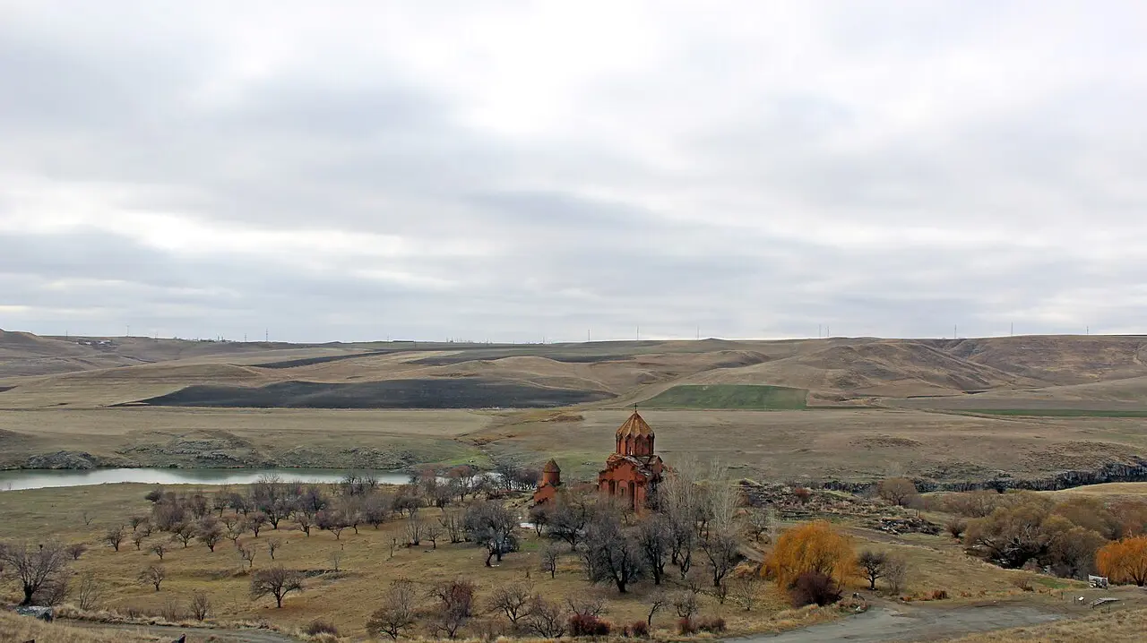 The red-tuff churches of Marmashen monastery standing in their valley above the Akhurian river in Shirak