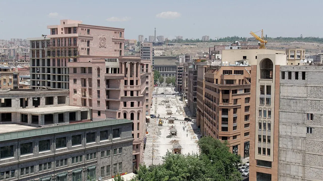 Pedestrians walking along Northern Avenue in central Yerevan under a clear sky