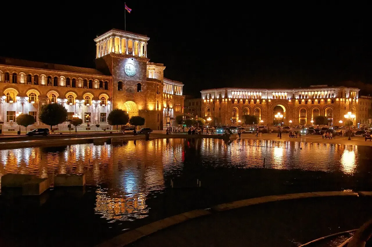 Republic Square in Yerevan lit up at night with fountains and surrounding buildings