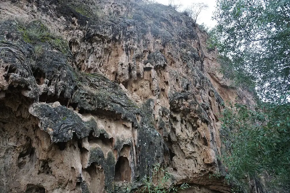 The travertine rock and turquoise mineral pools of the Devil's Bridge on the floor of the Vorotan gorge below Tatev