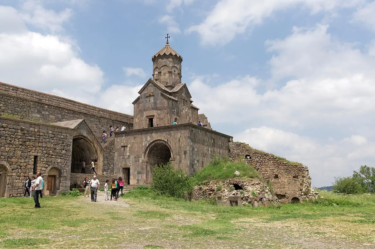 The full walled compound of Tatev monastery seen from above, its domed churches and cells clustered on the basalt plateau over the gorge