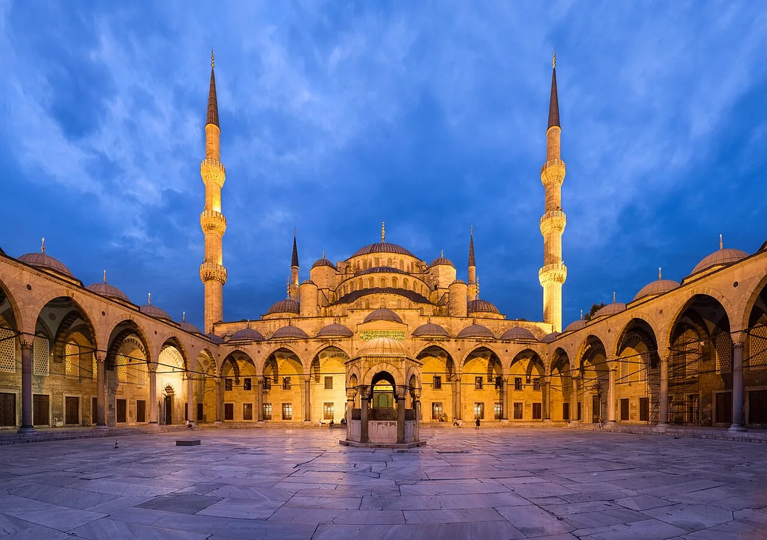 The turquoise-tiled courtyard and dome of the Blue Mosque in Yerevan at dusk