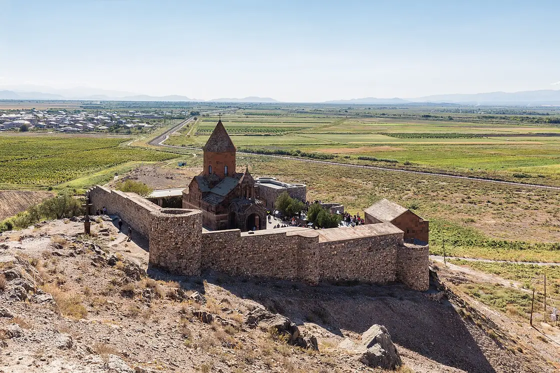 Khor Virap monastery on a hill with the snow-capped Mount Ararat rising behind it