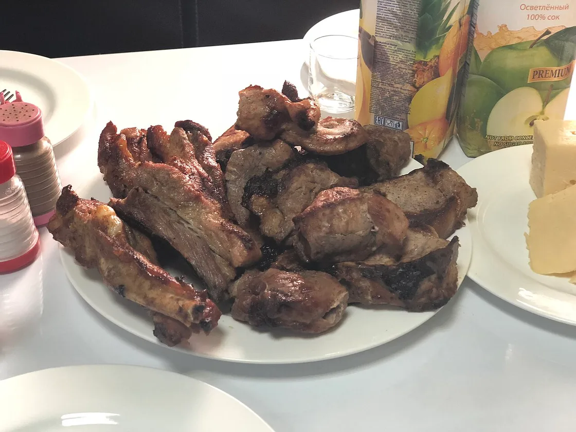 A plate of grilled khorovats, Armenian barbecue, with vegetables and lavash bread