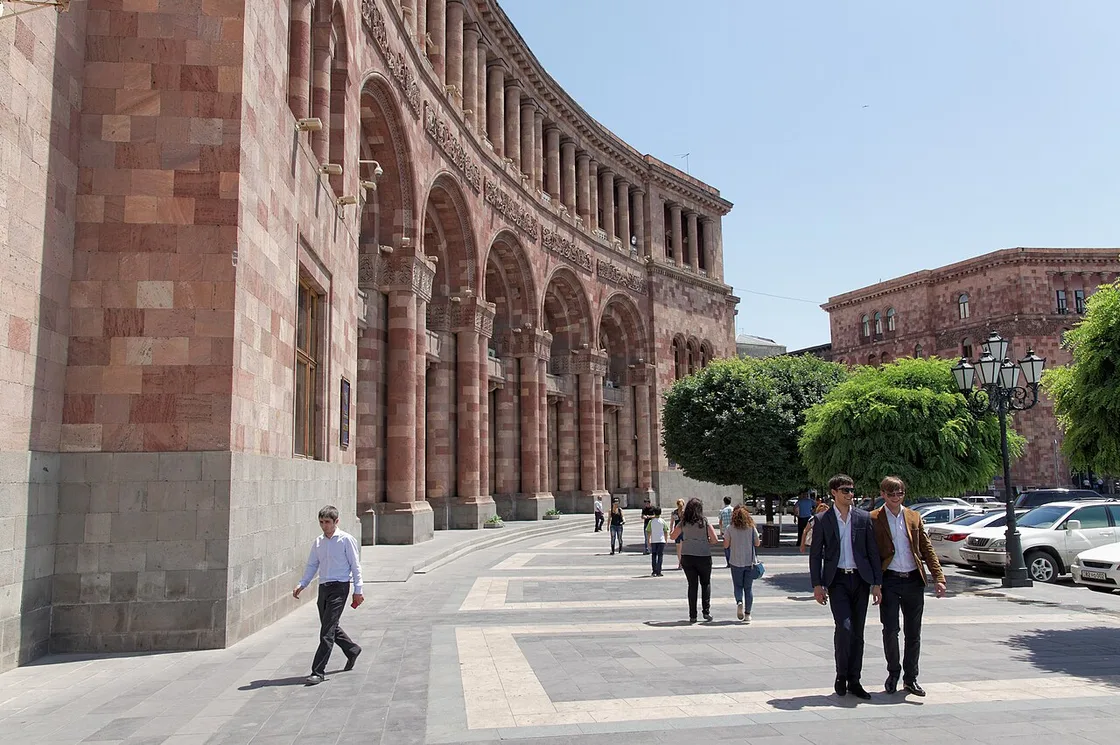 The pink and black tuff facades of Republic Square in Yerevan under a bright sky