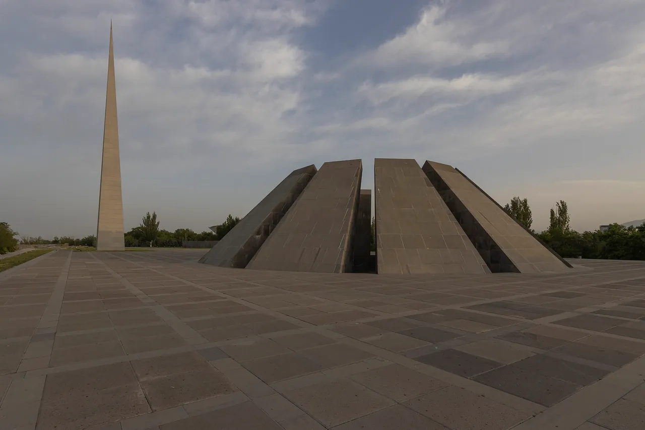 The Tsitsernakaberd memorial: the tall split stele and the ring of twelve leaning basalt slabs on the stone plaza in Yerevan