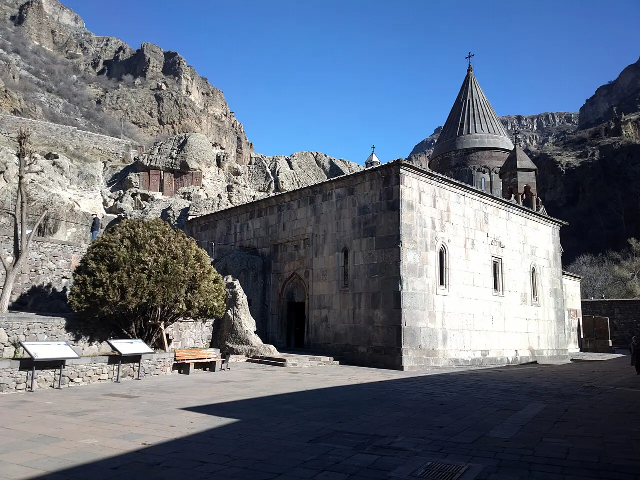 The rock-cut chambers and cliff face above the church buildings of Geghard monastery in the Azat valley