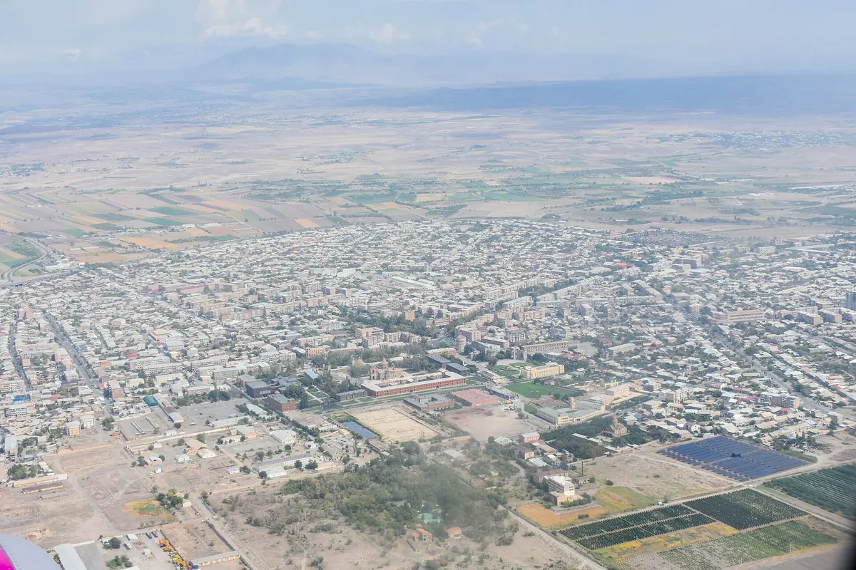 Aerial view of Vagharshapat with the walled Mother See complex and the town spreading across the Armavir plain