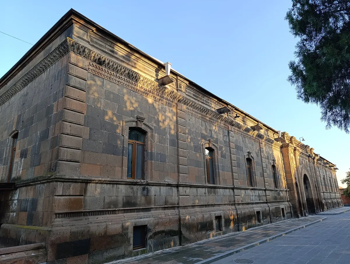 Saint Gayane Church, a low domed basilica of grey stone, in its walled yard at Vagharshapat