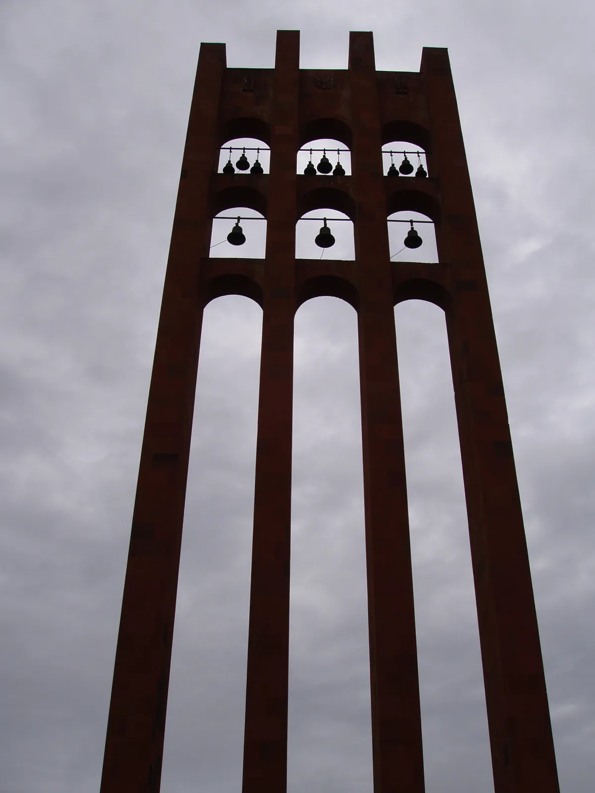 The red-tufa bell tower of the Sardarapat Memorial rising against the sky