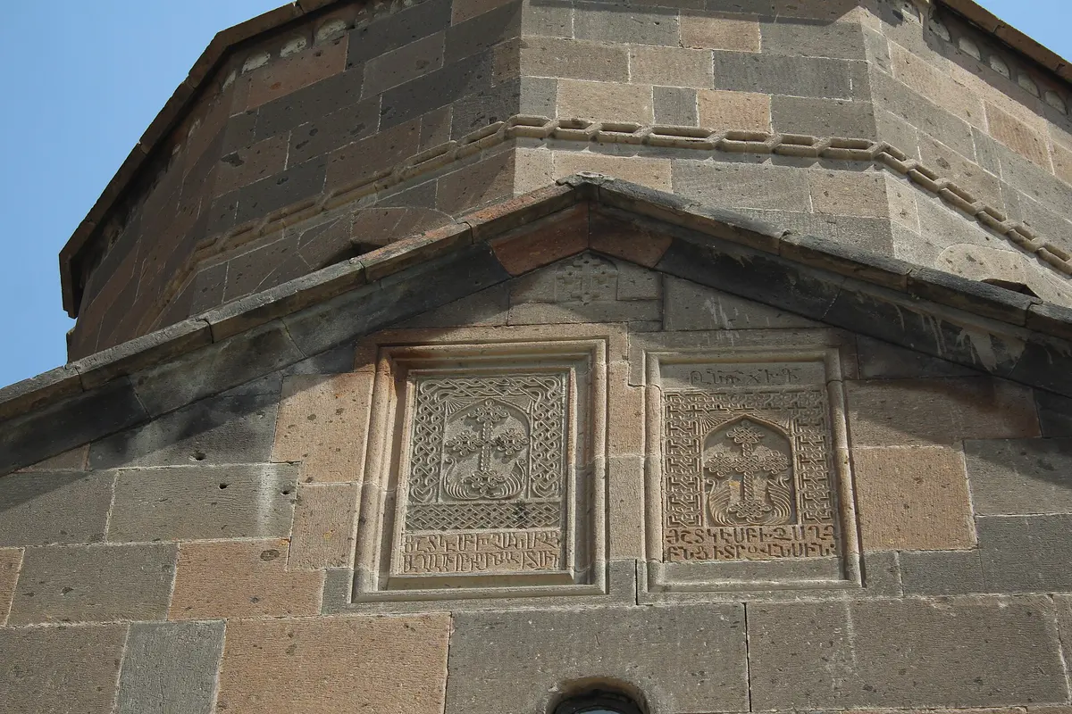The small single-nave Shoghakat Church of red and grey stone under a clear sky in Vagharshapat