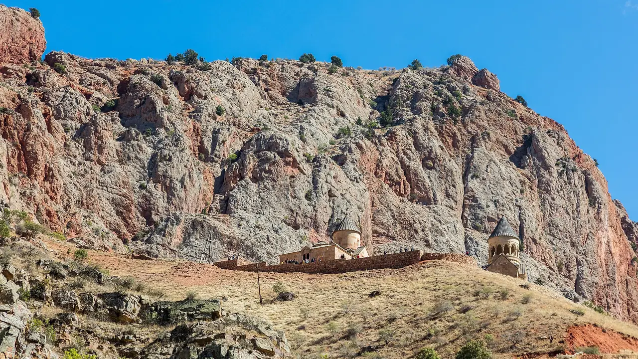 Noravank monastery set against the brick-red cliffs of the Amaghu gorge in Vayots Dzor