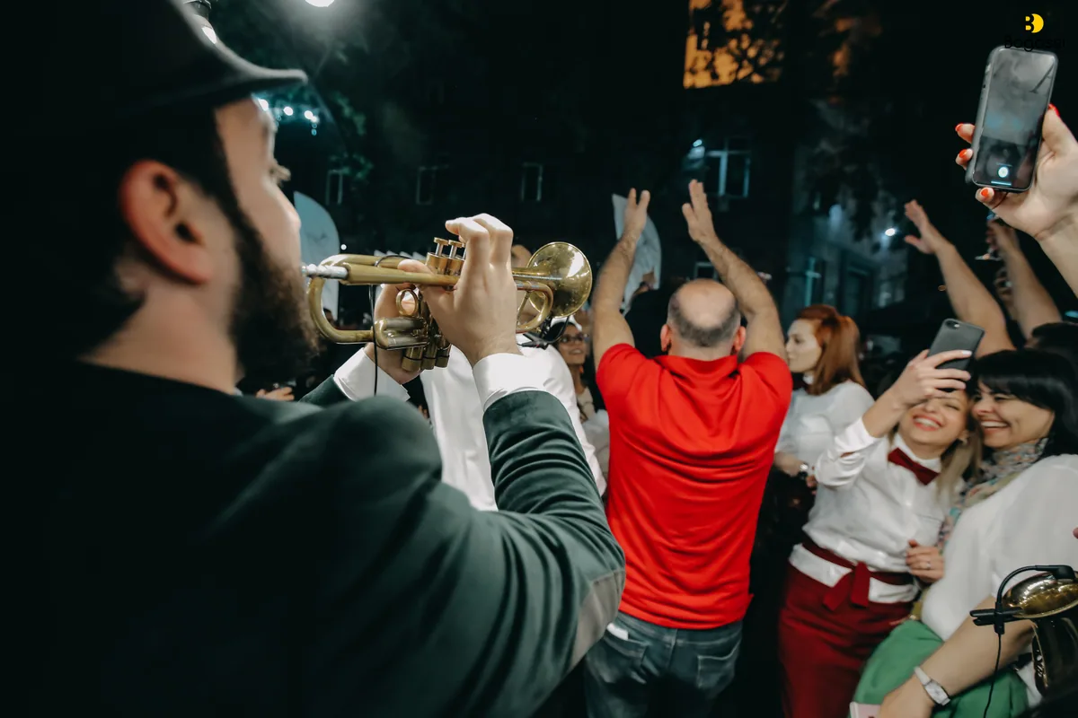 A brass band playing to a dancing evening crowd during Yerevan Wine Days on Saryan Street
