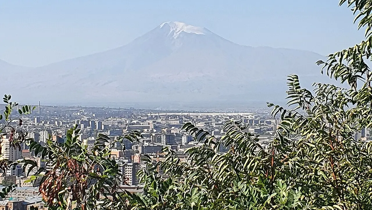 Mount Ararat rising beyond Yerevan under a clear sky from Victory Park