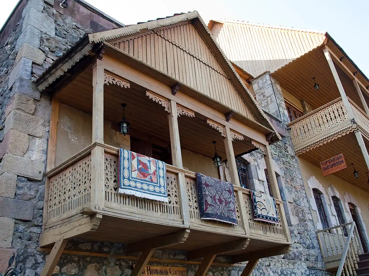 Carved wooden balconies hung with rugs above a Tufenkian showroom in the restored old quarter of Dilijan