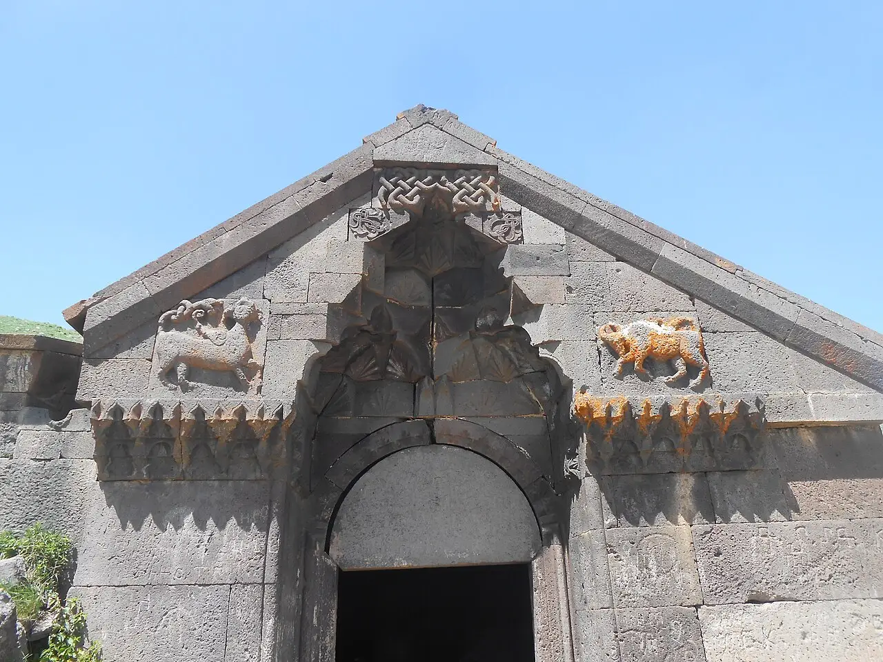 The carved basalt portal of Orbelian caravanserai with animal reliefs above the low arched doorway