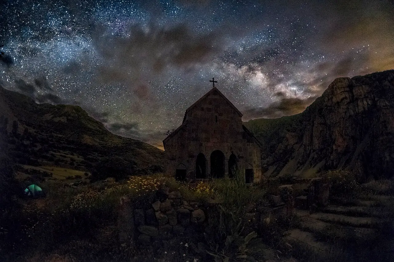 The open triple-arched west front of Zorats Church at Yeghegis under the Milky Way at night