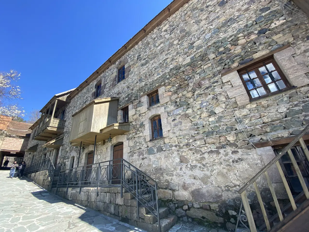 Restored stone houses with carved wooden balconies on Sharambeyan Street in Old Dilijan