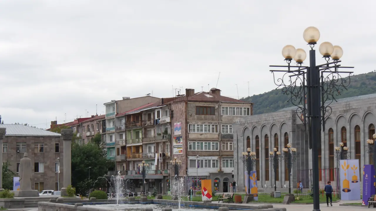 The town of Goris in southern Armenia spread across a green valley ringed by mountains