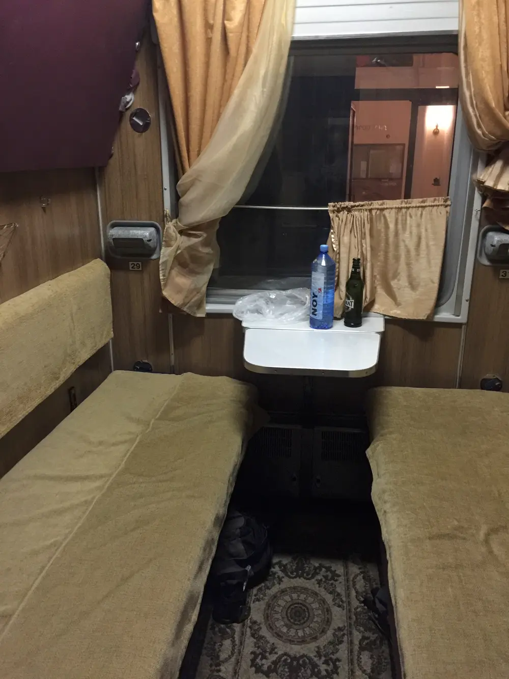 The interior of a four-berth kupe sleeping compartment on the overnight Caucasus train with made-up bunks