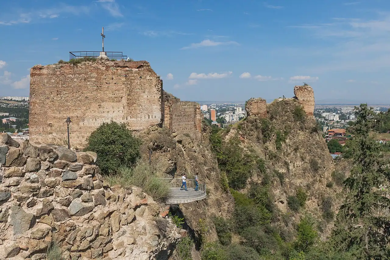 The old town of Tbilisi climbing the hillside below the stone walls of the Narikala fortress