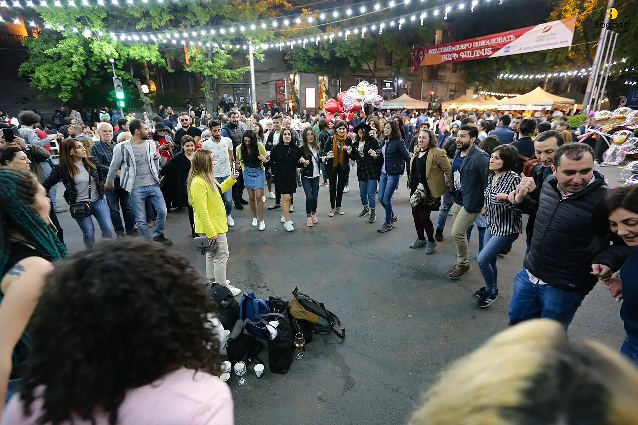 Dancers in traditional dress performing a round dance on Saryan Street during Yerevan Wine Days