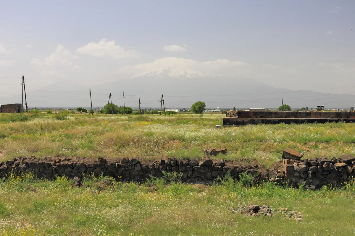 A low-angle view across the foundations of Zvartnots showing the tetraconch plan of the collapsed cathedral